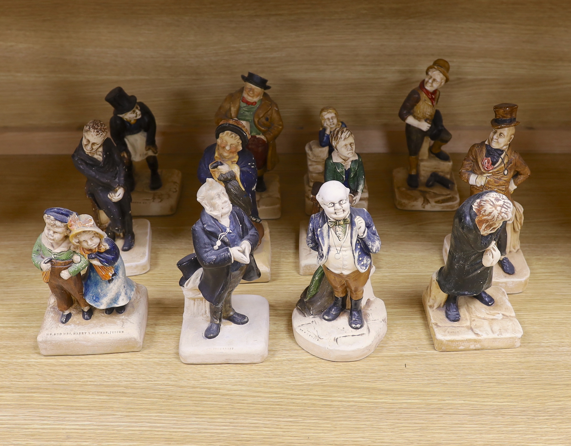 A collection of twelve Bretby cold painted pottery Dickens character figures, tallest Mr. Micawbee 25cm high